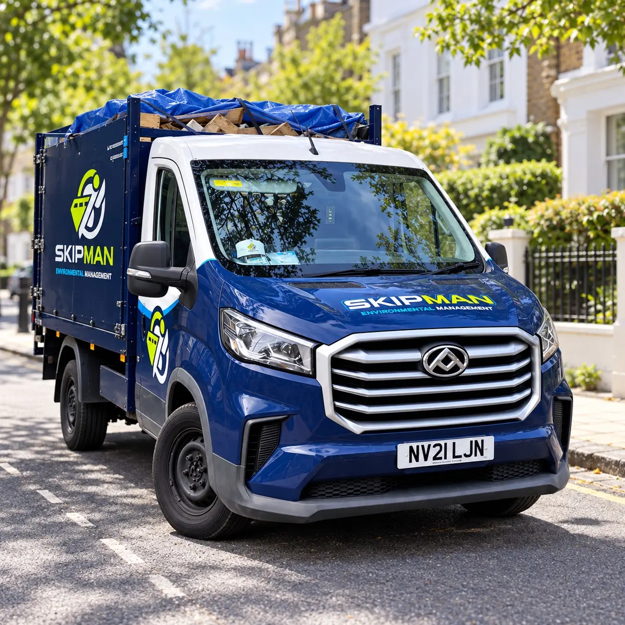 SKIPMAN branded cage van ready for rubbish collection in London