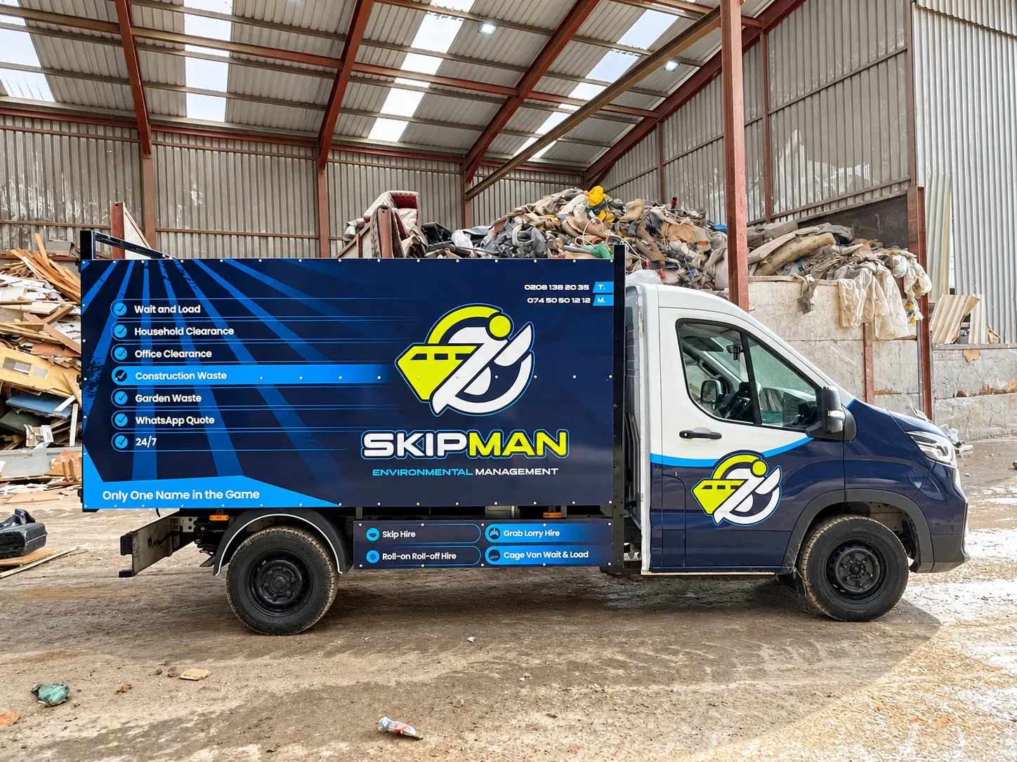 Side view of the branded SKIPMAN cage van