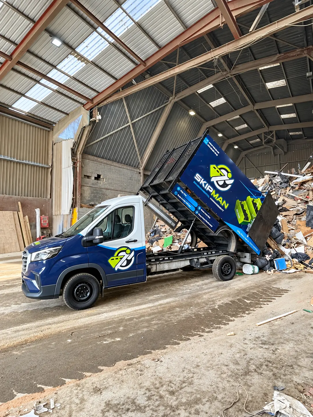 SKIPMAN cage van unloading collected waste at a transfer station