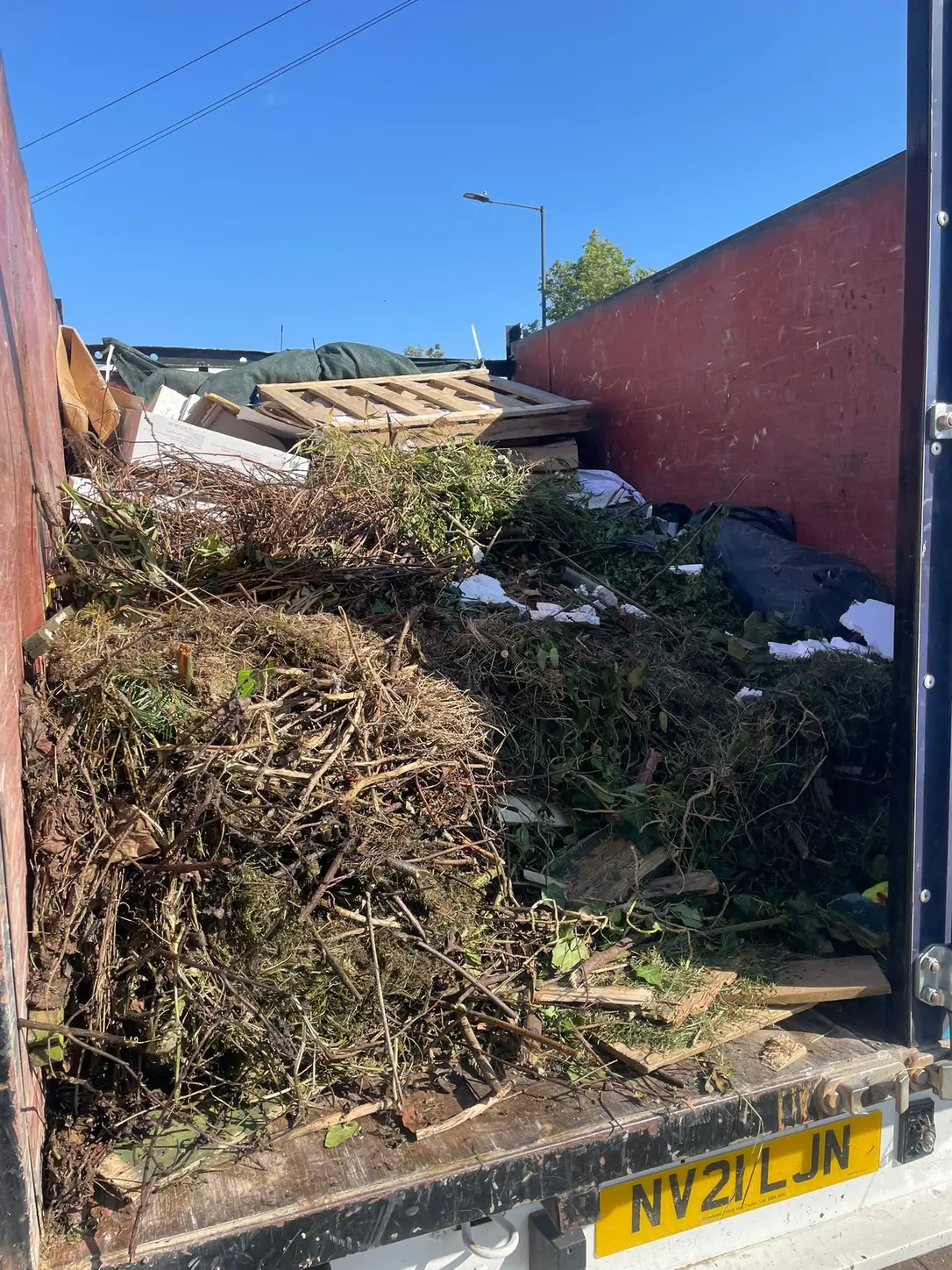 Garden waste and branches loaded for a SKIPMAN collection