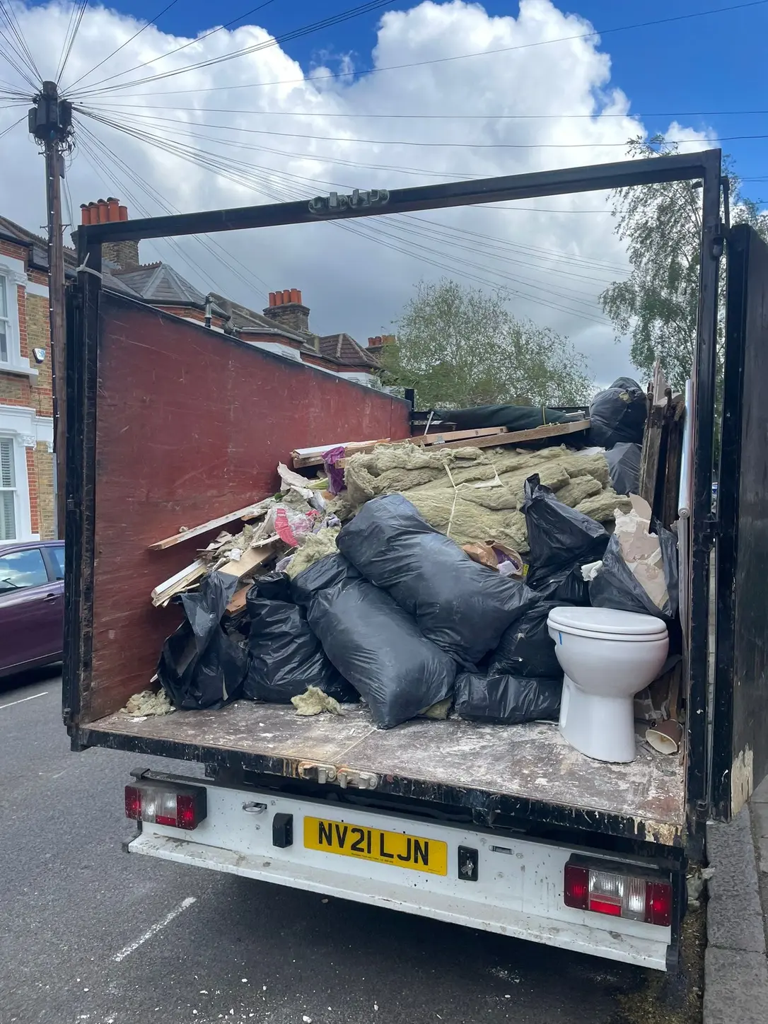 SKIPMAN cage van loaded with household renovation and insulation waste