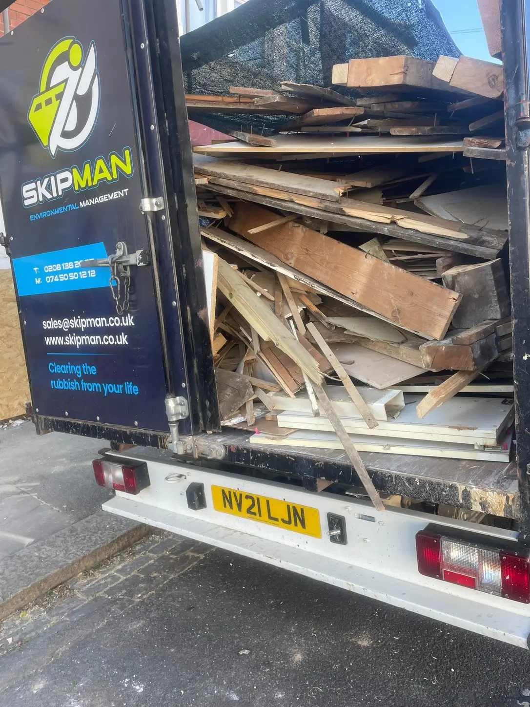 Timber and building waste loaded into the SKIPMAN cage van